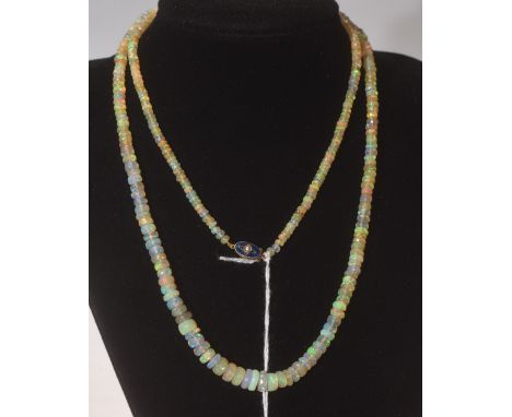 An opal bead necklace on a 15ct gold enamel and seed pearl set clasp, 72cm long