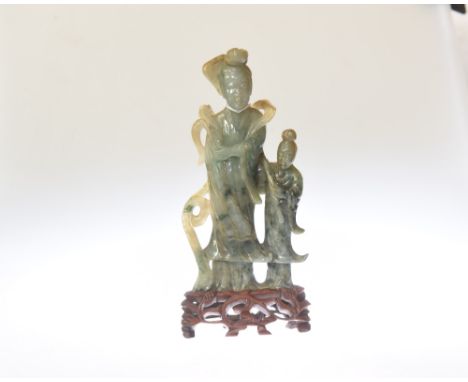A Chinese carved green hardstone figure group, poss. spinach jade, on a hardwood stand. Height 24cm