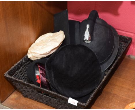 A Police Officer's helmet, a mortar board and three vintage hats