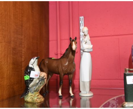 A Beswick figure of a Lesser Spotted Woodpecker, no. 2420, together with a large Beswick figure of a dark bay horse and a Nao