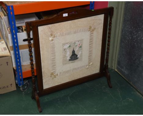 A 19th century silk and lace handkerchief mounted as a firescreen in an oak turned frame