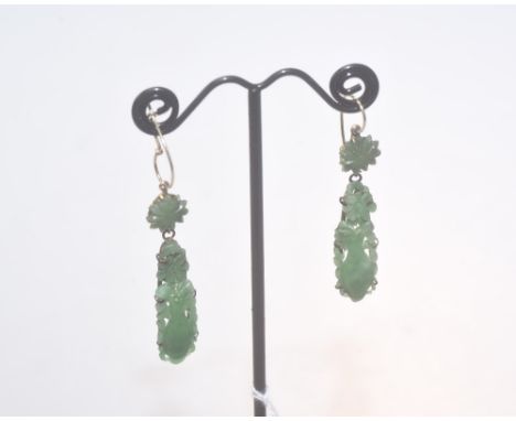 A pair of carved jade drop earrings, decorated with flowers