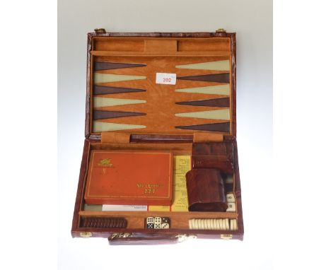 A leather bound backgammon set together with two shakers, dice, and a State Express 777 tin cigarette box. 