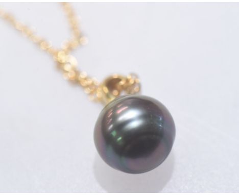 A Tahitian black pearl pendant on an 18ct gold chain. 