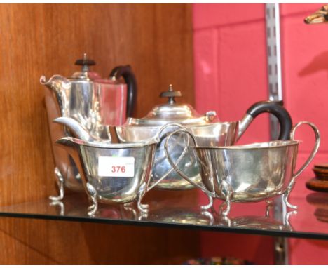A four piece Sheffied electroplated tea service of shaped rectangular form with ebonised wood handles and finials 