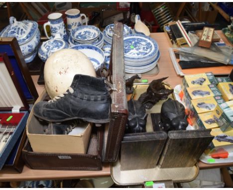 A vintage suitcase containing early 20th century football boots, vintage motor cycle helmet, a vintage Raleigh chrome bicycle