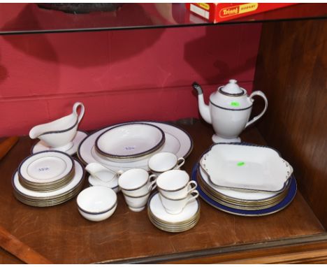 A Spode porcelain 'Lausanne' pattern dinner service, white with blue and gilt border, comprising six dinner plates, six desse