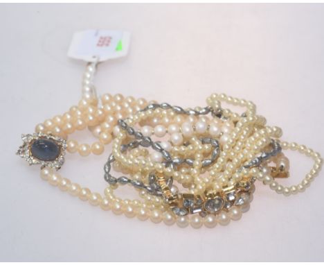 A group of faux and cultured pearl necklaces including a triple strand choker, single strand set with paste stones etc