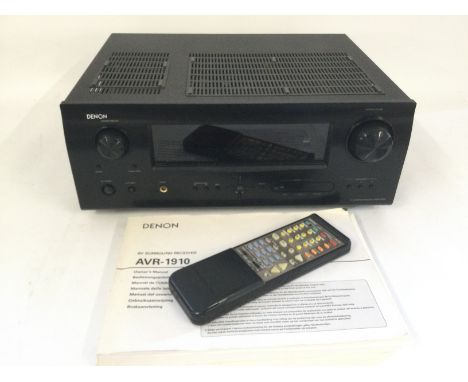 A boxed Denon AVR-1910 AV Surround receiver with remote, power supply and manual.