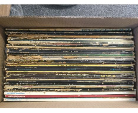A box of 1970s rock LPs by various artists including Jimi Hendrix, David Bowie, Jeff Beck and others.