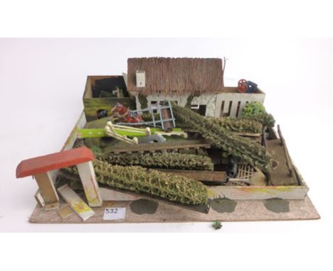 A scratch built wooden farm with various accessories including sponge hedges, fences Britains shire horse and roller, diecast