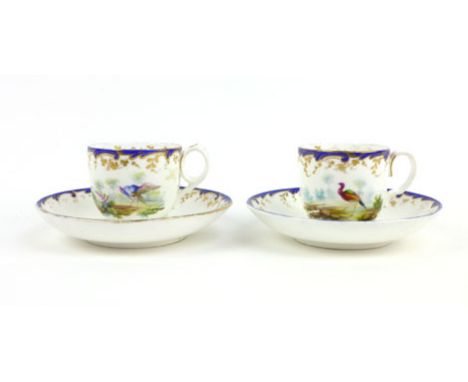 A pair of 19th century cabinet cup and saucers decorated with exotic birds within blue and gilt borders, d. 14.5 cm (saucer)