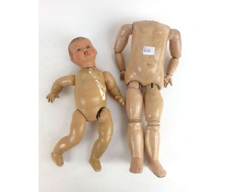 An early 20th century  ceramic doll with posable arms and legs, hand painted features together with a early 20th century pape