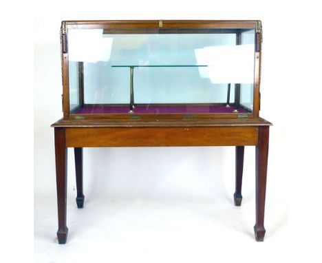 A mahogany framed glazed display cabinet on a table base with tapering square section legs and an inner glazed shelf, h. 138 