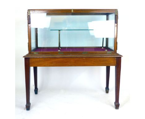 A mahogany framed glazed display cabinet on a table base with tapering square section legs and an inner glazed shelf, h. 138 