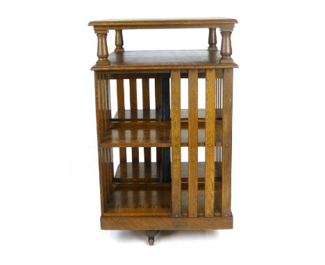 An Edwardian oak revolving bookcase with raised upper shelf and numbered bookshelves, h. 115 cm, w. 67 cm CONDITION REPORT: G