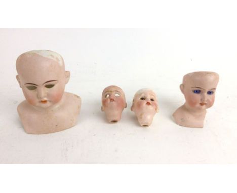 Four various early 20th century German Armand Marseille style ceramic dolls heads, some with glass eyes, painted features som