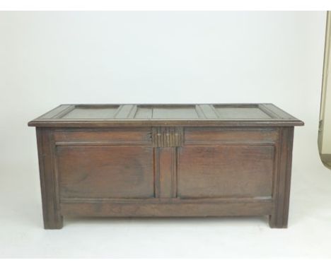 An 18th century oak coffer with triple panel cover, vacant interior and double panelled front, w. 317 cm CONDITION REPORT: Su