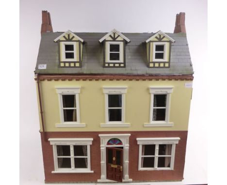A modern dolls house modelled as a double fronted town house with sash windows and a rear extension, wired for electricity, w