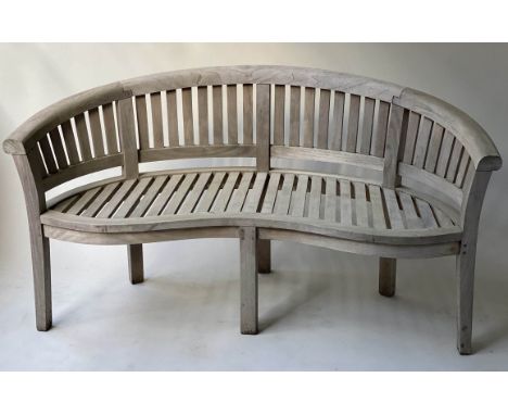 'BANANA' GARDEN BENCH, weathered teak of slatted construction and arched form, 161cm W. 