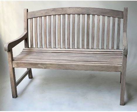 GARDEN BENCH, weathered teak of slatted construction with arched back, 121cm W. 