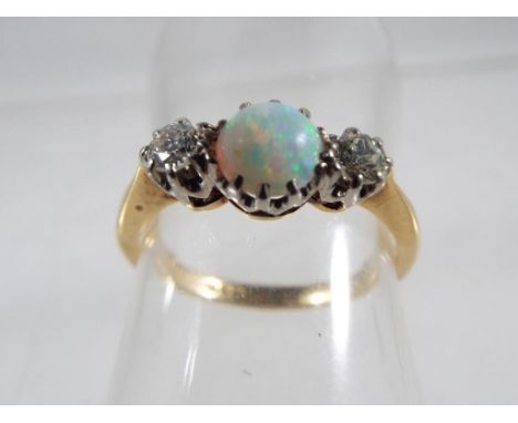 A lady's hallmarked 18 carat yellow gold and platinum three-stone opal and diamond ring, approx 2.64 gm, size K + 1/2, approx