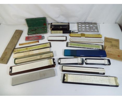 A boxed Otis King patent calculator model K, a cased set of drawing instruments, slide rules and similar.  