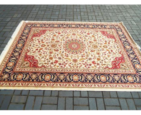 A Keshan carpet with a beige ground, approx 280cm x 200cm, Est £100 - £120