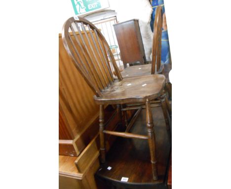 A pair of old hoop stick back kitchen chairs with solid elm seats, set on turned supports
