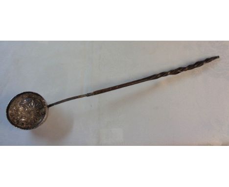 A late Georgian white metal toddy ladle with embossed decoration to bowl and slightly perished twisted whalebone handle