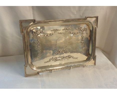 A 30cm silver dressing table tray with stepped beaded corners and embossed decoration