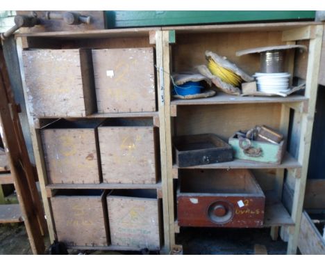 Two wooden workshop shelving units with loose drawers containing assorted ironmongery and a small homemade wooden work bench 