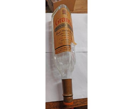 A large vintage Grant's stand fast Scotch Whiskey optic bottle with remains of original label