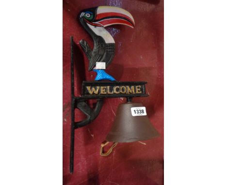 A modern painted cast iron porch bell with Guinness toucan finial
