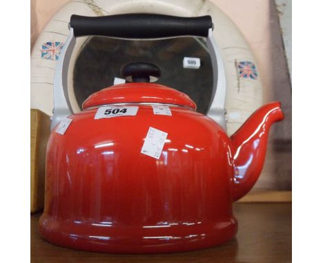 A modern Le Creuset kettle in red enamel finish
