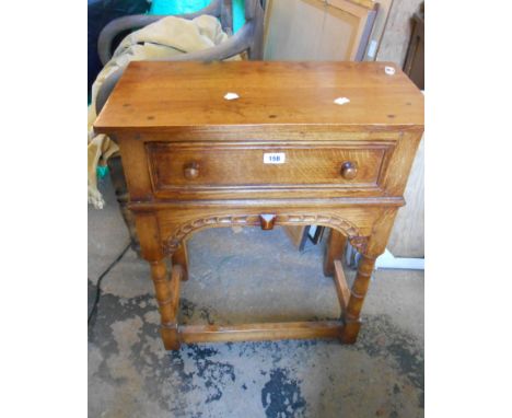 A 60cm polished oak side table in the antique style with frieze drawer and carved apron, set on ring turned front supports