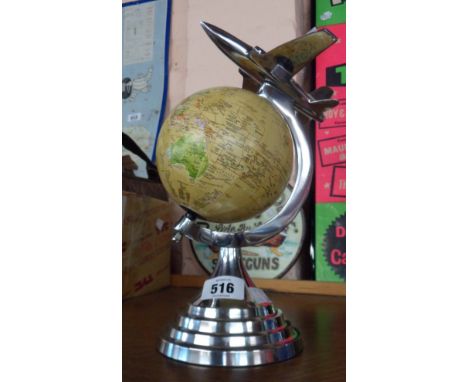 A modern Art Deco style globe with aeroplane finial