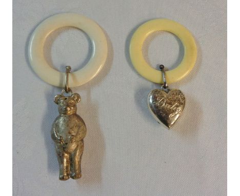 A composite teething ring with silver heart shaped rattle marked 'Baby' - sold with another silver plated bear pattern simila