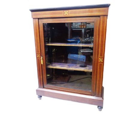 A 79cm late Victorian inlaid mahogany pier cabinet with velvet lined interior enclosed by a glazed panel door, set on turned 