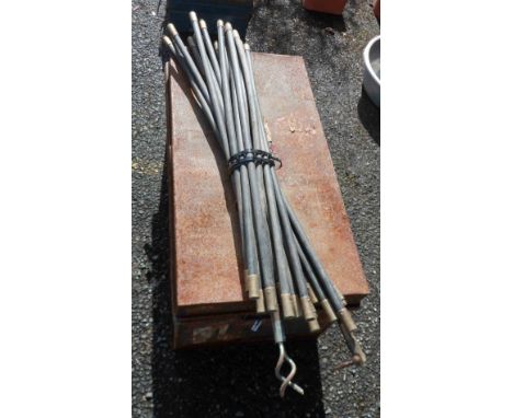 An old tin trunk - sold with a set of drain rods and an old two wheel pot mover