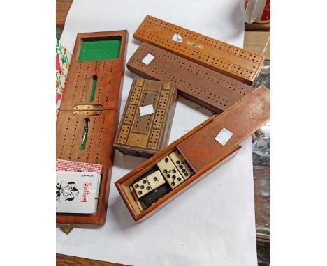 A box containing a quantity of cribbage boards, playing cards and a bone and ebony domino set