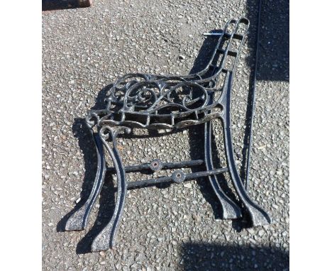 A pair of painted cast iron bench ends and connecting rod
