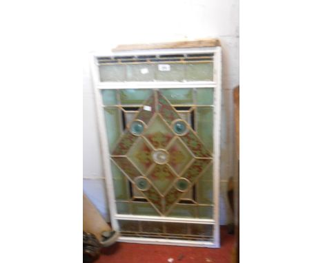 A Victorian stained glass window panel with bosses and repeat geometric design - 90cm X 49cm