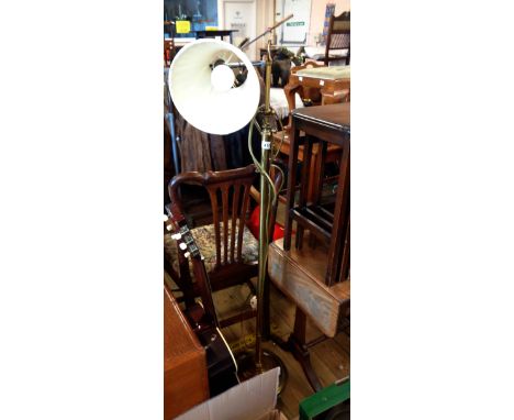 A Christopher Wray brass standard reading lamp with poseable top section and shade, set on a circular base