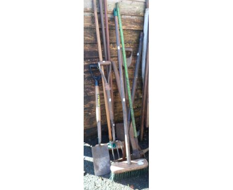 A selection of old garden tools including Stanley spade, shovels, forks, brushes, etc.