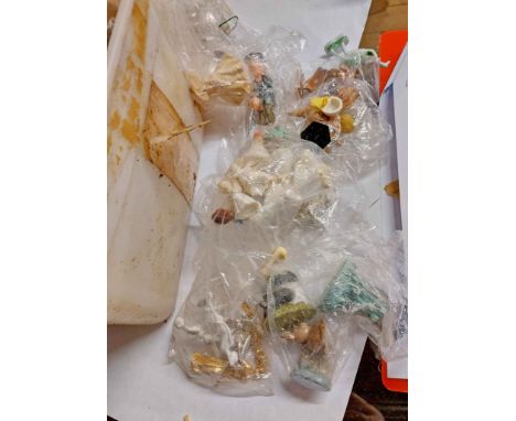 A tub containing a quantity of ceramic and other cake decorations, figurines, etc.