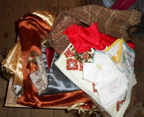 A wooden crate containing a quantity of assorted textiles including embroidered bedspread, tray cloths, etc.