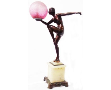 A 1930's Art Deco table lamp in the form of a stylised dancing girl with bronzed finish on an alabaster plinth with bronzed m