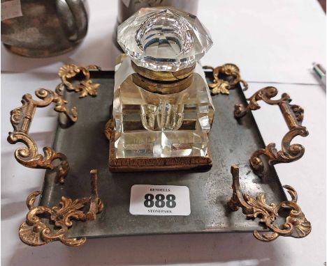 A Victorian inkwell with metal tray and ormulu handles, mounts and pen stand with central cut glass lift-top ink well