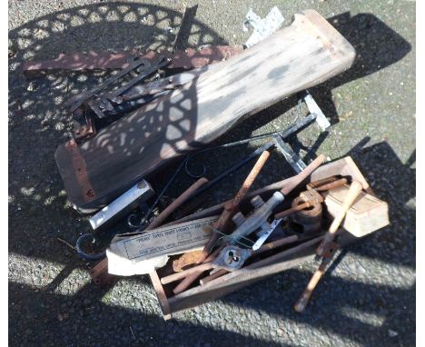 A wooden box containing a quantity of old tools including tap and die, etc. - sold with a quantity of cast iron items
